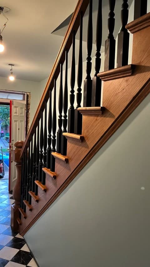 Wood staircase with a dark finished railing